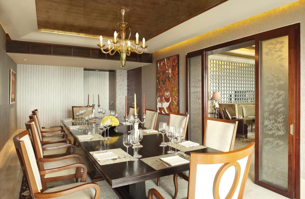 a dining room with a long table and chairs at The Leela Ambience Gurugram Hotel & Residences - The Luxury Urban Sanctuary in Gurgaon