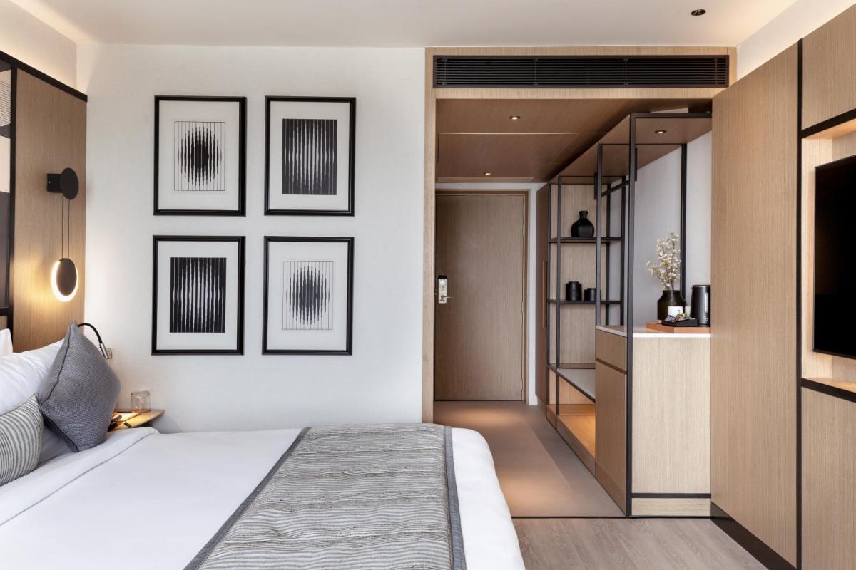a bedroom with a bed and a tv on a wall at Parallel Hotel Udaipur, a member of Radisson Individuals in Udaipur