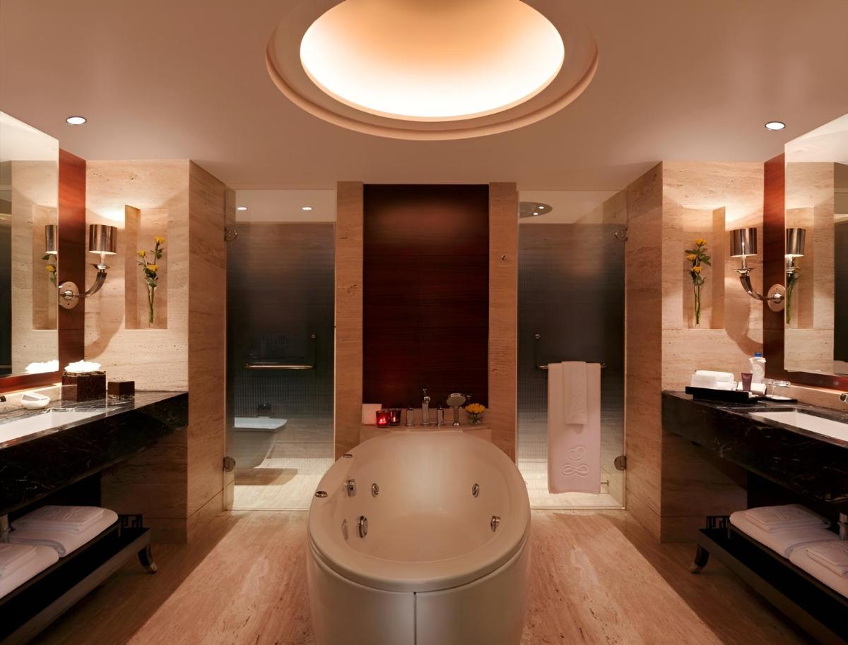 a large bathroom with a tub and two sinks at The Leela Ambience Gurugram Hotel & Residences - The Luxury Urban Sanctuary in Gurgaon