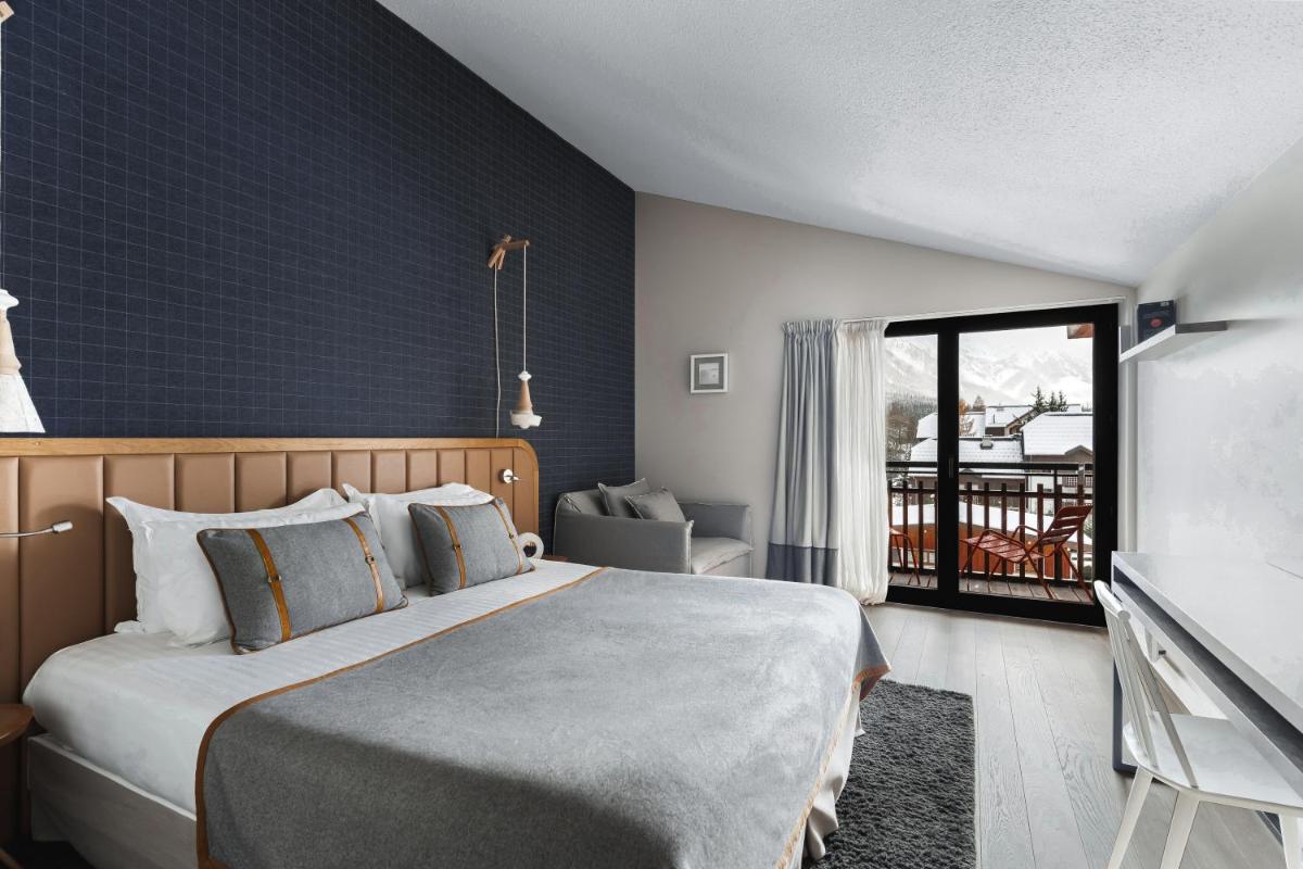 une chambre d'hôtel avec un lit et une télévision dans l'établissement Heliopic Hotel & Spa, à Chamonix-Mont-Blanc