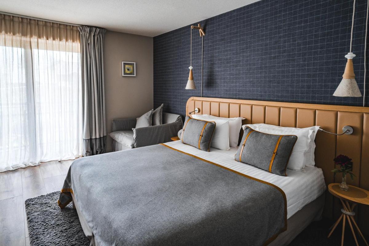Un ou plusieurs lits dans un hébergement de l'établissement Heliopic Hotel & Spa
