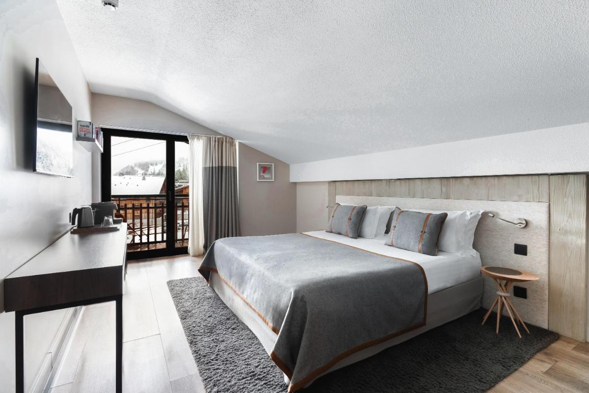 Un ou plusieurs lits dans un hébergement de l'établissement Heliopic Hotel & Spa