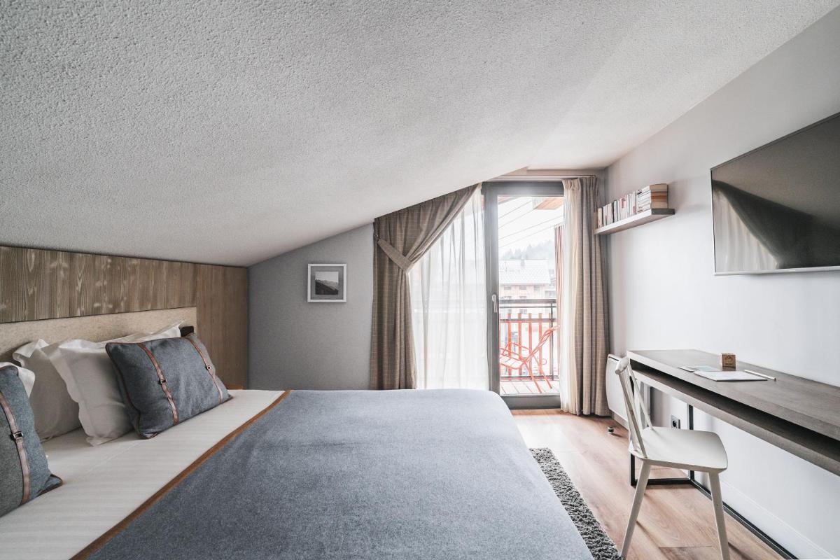 Un ou plusieurs lits dans un hébergement de l'établissement Heliopic Hotel & Spa