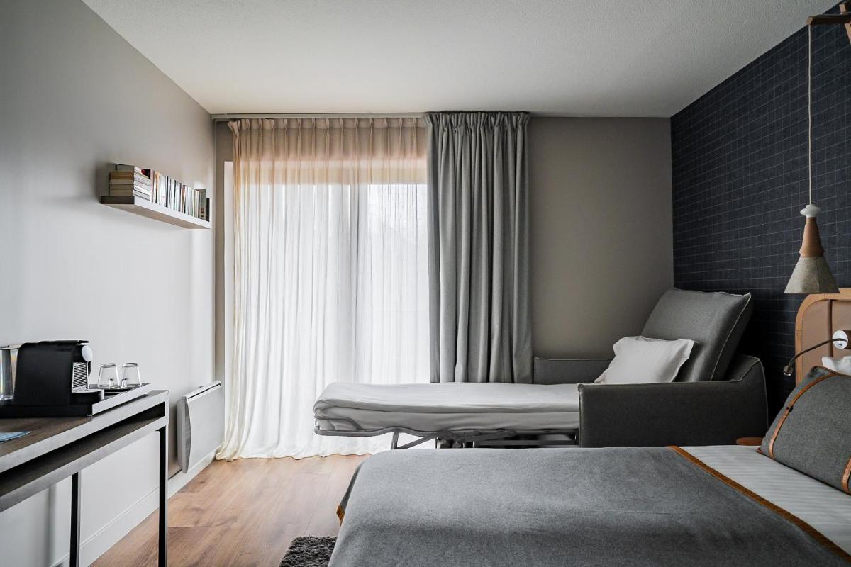 Un ou plusieurs lits dans un hébergement de l'établissement Heliopic Hotel & Spa