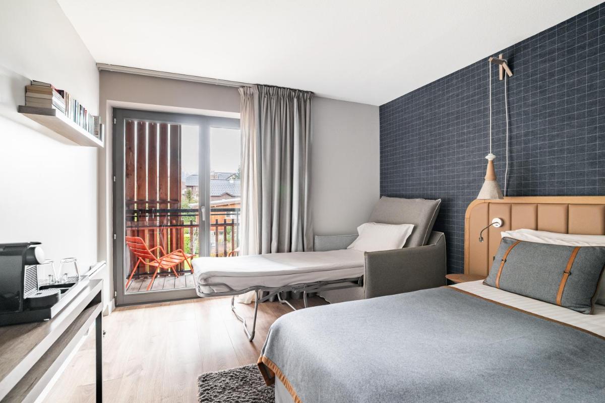 Un ou plusieurs lits dans un hébergement de l'établissement Heliopic Hotel & Spa