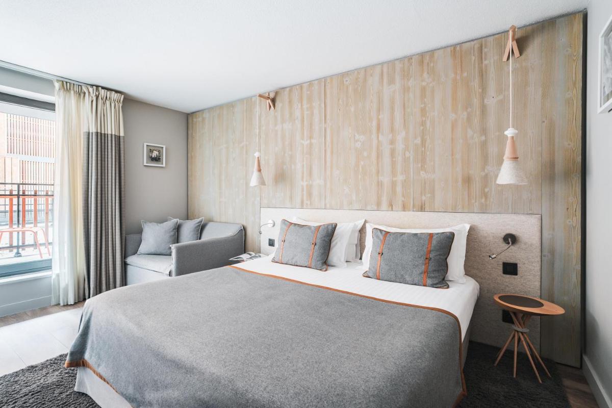 Un ou plusieurs lits dans un hébergement de l'établissement Heliopic Hotel & Spa