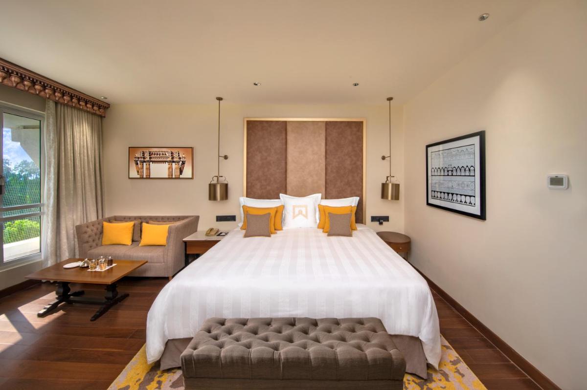 a large bedroom with a large bed and a couch at ITC Kakatiya, a Luxury Collection Hotel, Hyderabad in Hyderabad