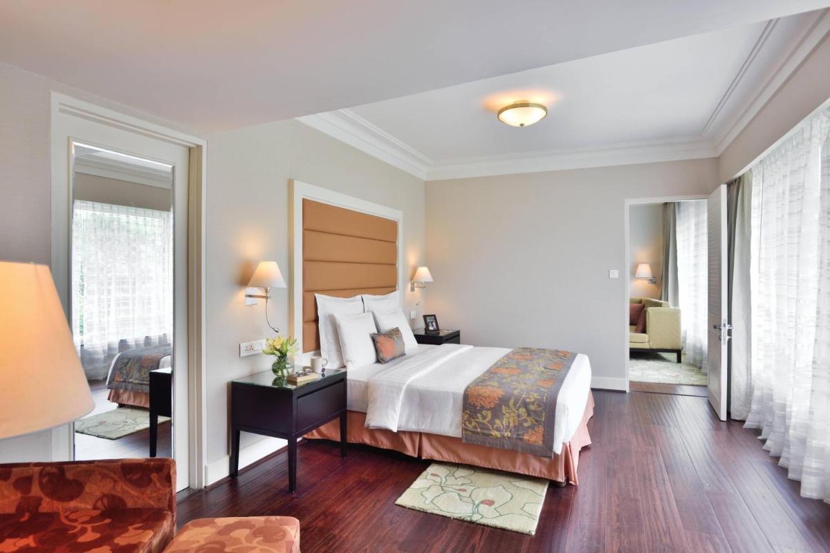 a hotel room with a bed and a chair at Marriott Executive Apartment - Lakeside Chalet, Mumbai in Mumbai