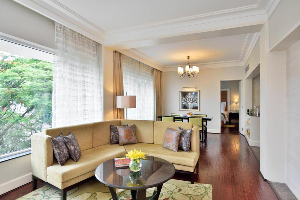 a living room with a couch and a table at Marriott Executive Apartment - Lakeside Chalet, Mumbai in Mumbai