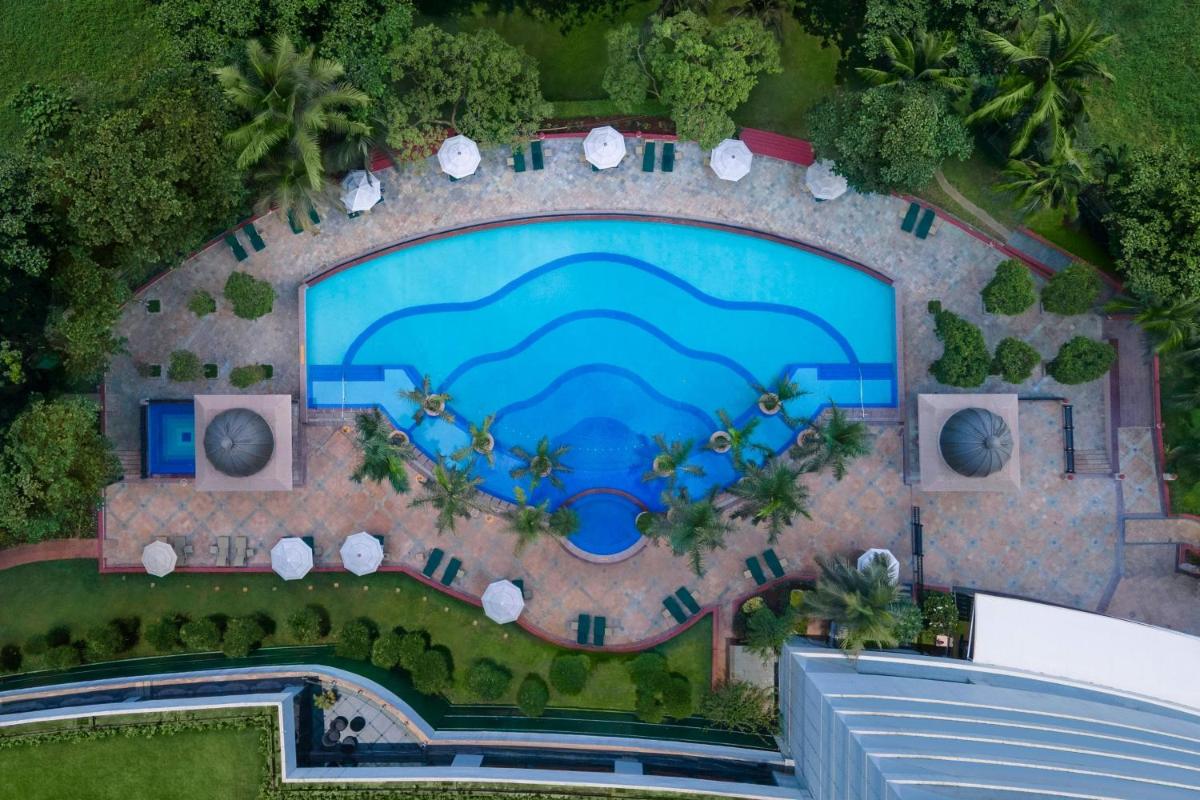 an overhead view of a pool at a resort at The Westin Mumbai Powai Lake in Mumbai