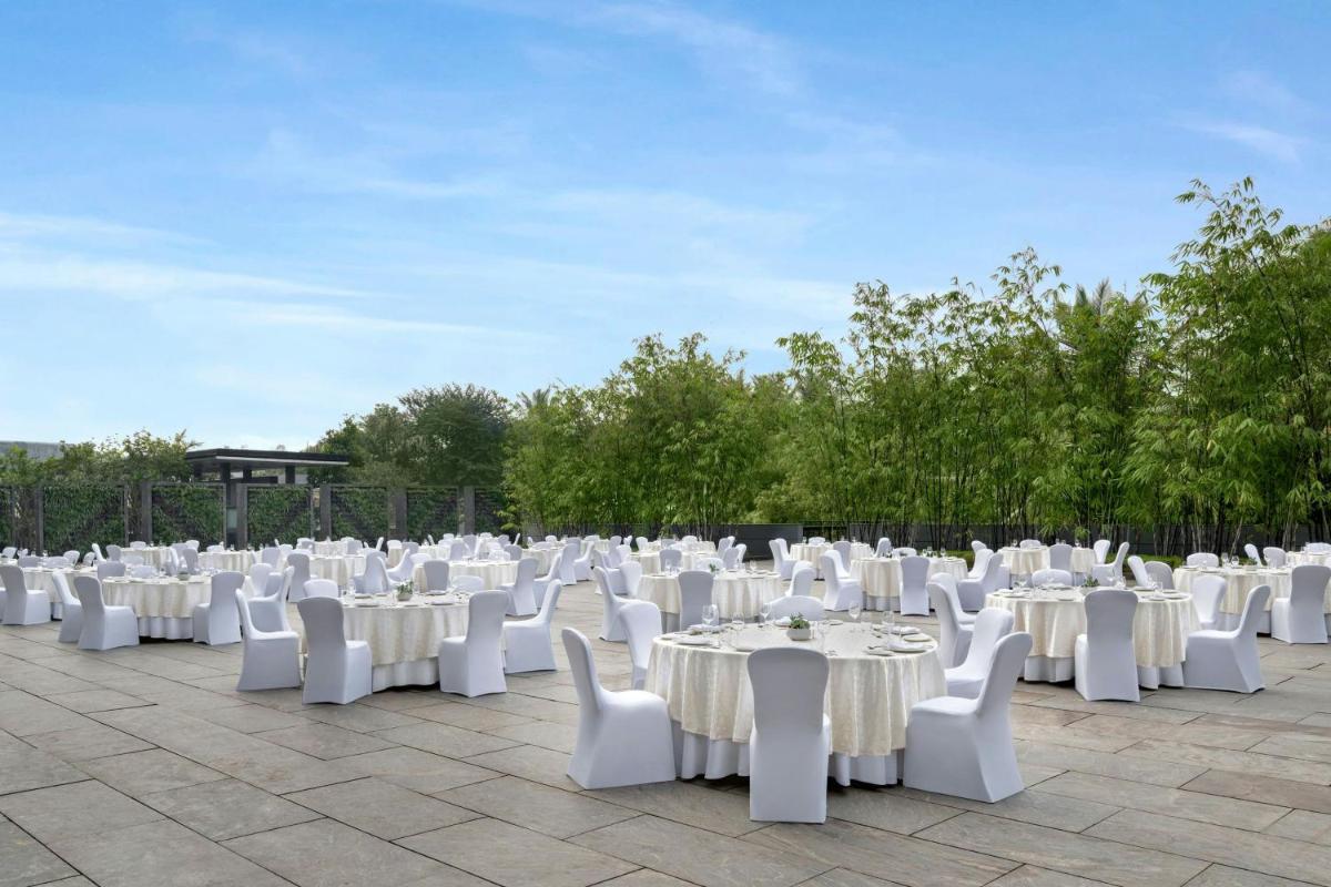 a group of white tables and white chairs at JW Marriott Pune in Pune