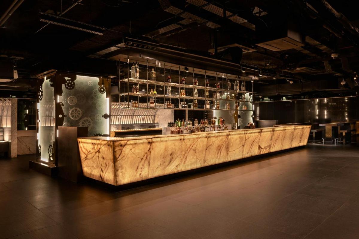 a bar with a marble counter in a room at JW Marriott Pune in Pune
