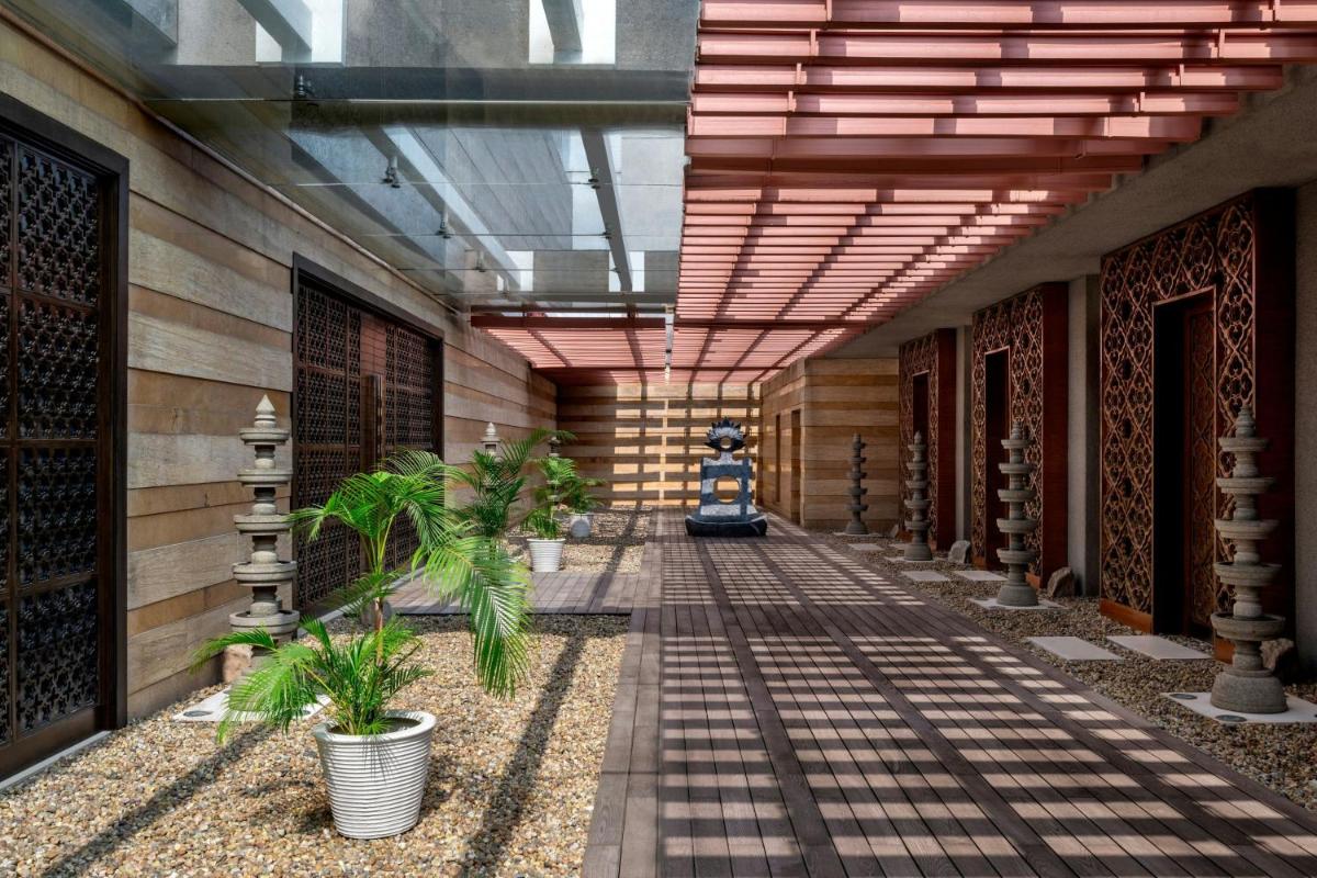 a hallway of a building with plants and a ceiling at JW Marriott Pune in Pune