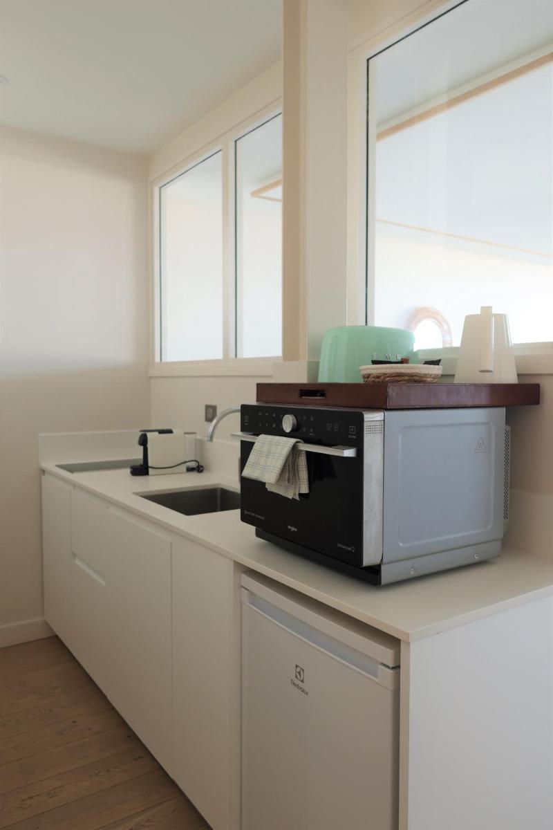 Cuisine ou kitchenette dans l'établissement Résidence Les Suites du Port - by Le Saint Ferdinand
