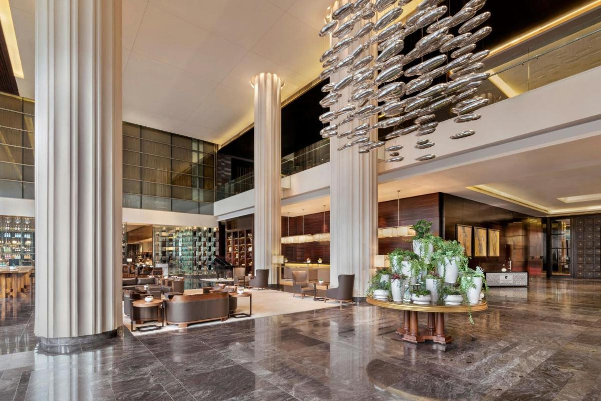 a lobby of a hotel with a bunch of wine glasses at JW Marriott Pune in Pune