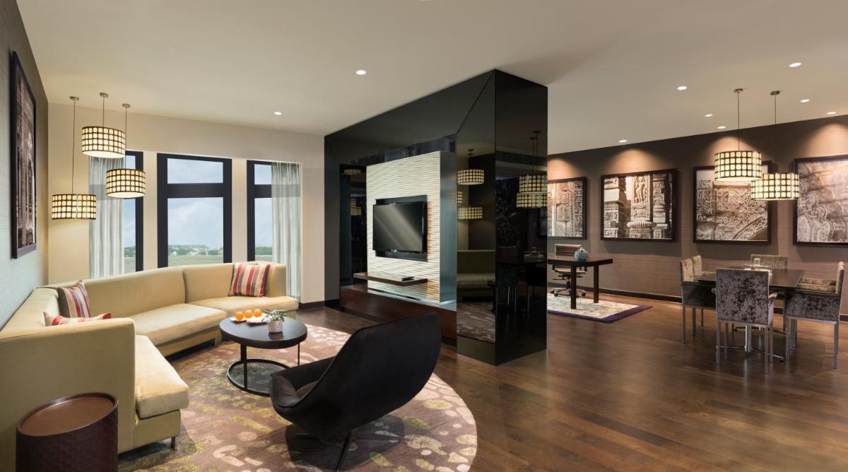 a living room with a couch and a table at Pullman New Delhi Aerocity in New Delhi a living room with a couch and a table at Pullman New Delhi Aerocity in New Delhi
