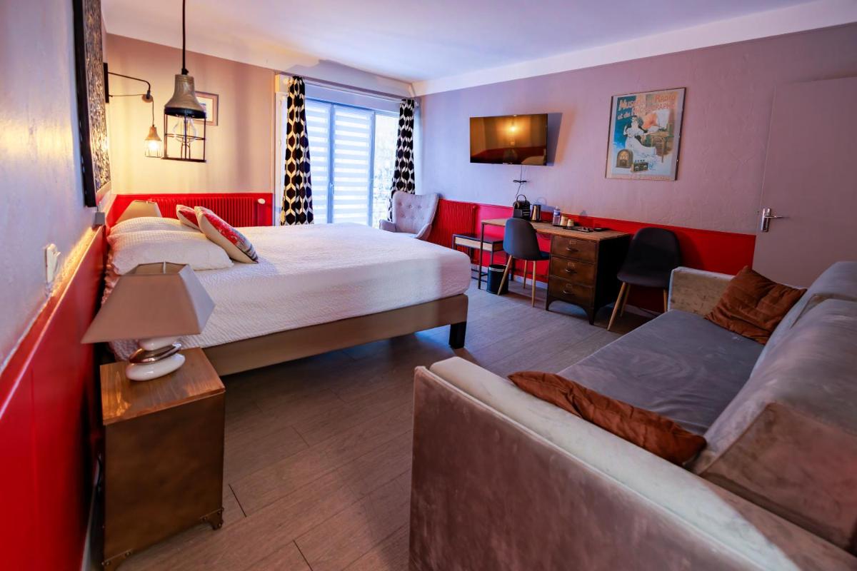 Un ou plusieurs lits dans un hébergement de l'établissement Logis Central Hôtel - Restaurant & Spa
