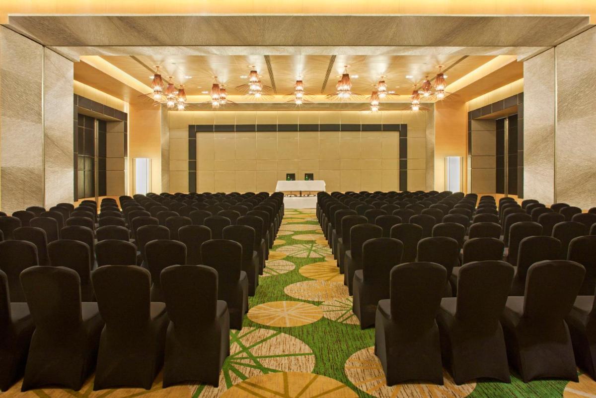 an empty hall with chairs and a table in it at Radisson Blu Hotel Amritsar in Amritsar
