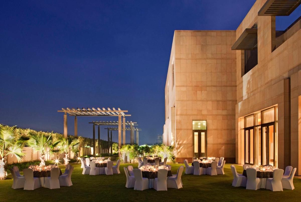 a venue with tables and chairs in front of a building at Radisson Blu Hotel Amritsar in Amritsar