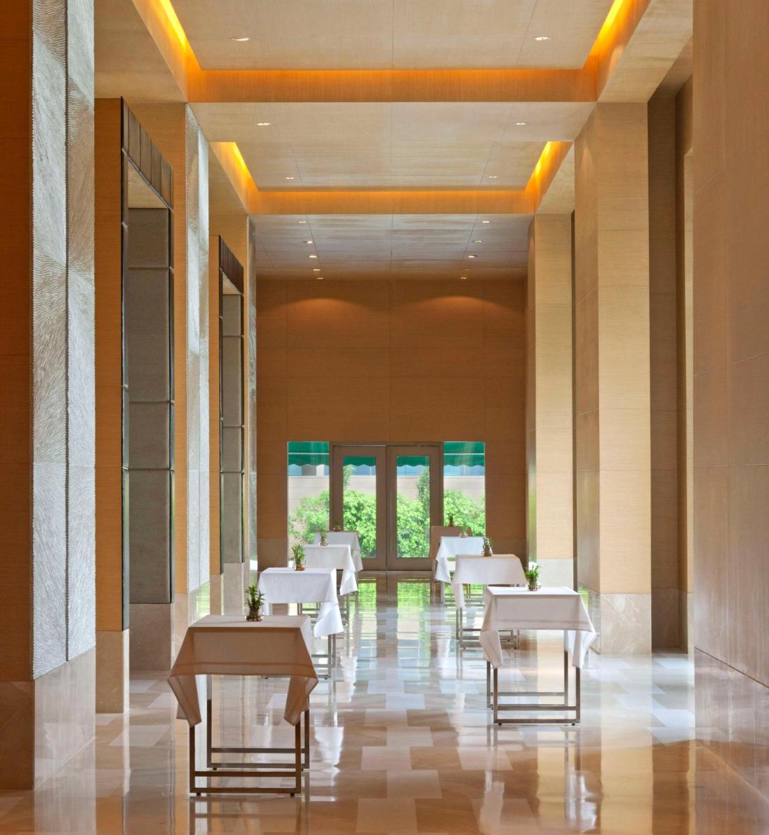 a dining room with white tables and chairs at Radisson Blu Hotel Amritsar in Amritsar