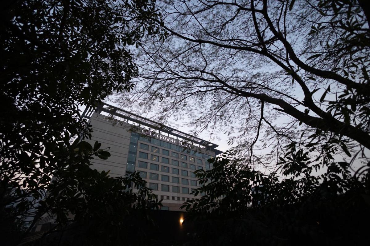 a tall building with trees in front of it at Crowne Plaza Today Gurugram by IHG in Gurgaon