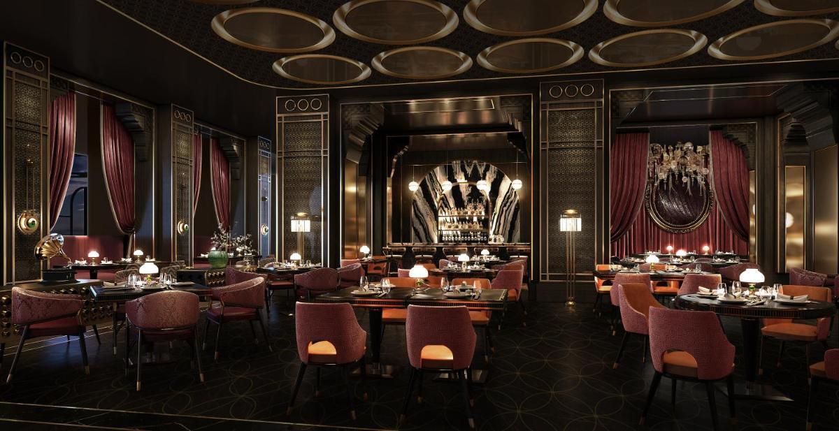 a restaurant with tables and chairs in a room at Fairmont Mumbai in Mumbai