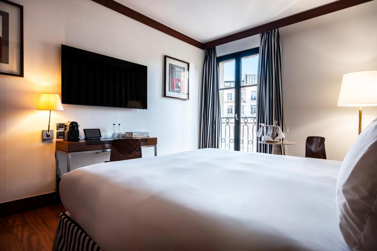 Un ou plusieurs lits dans un hébergement de l'établissement Grand Hôtel Champs-Elysées