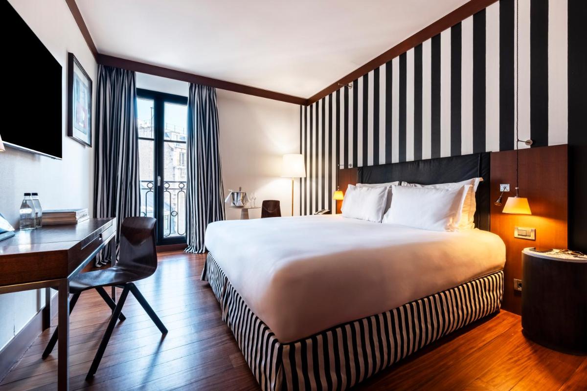 Un ou plusieurs lits dans un hébergement de l'établissement Grand Hôtel Champs-Elysées