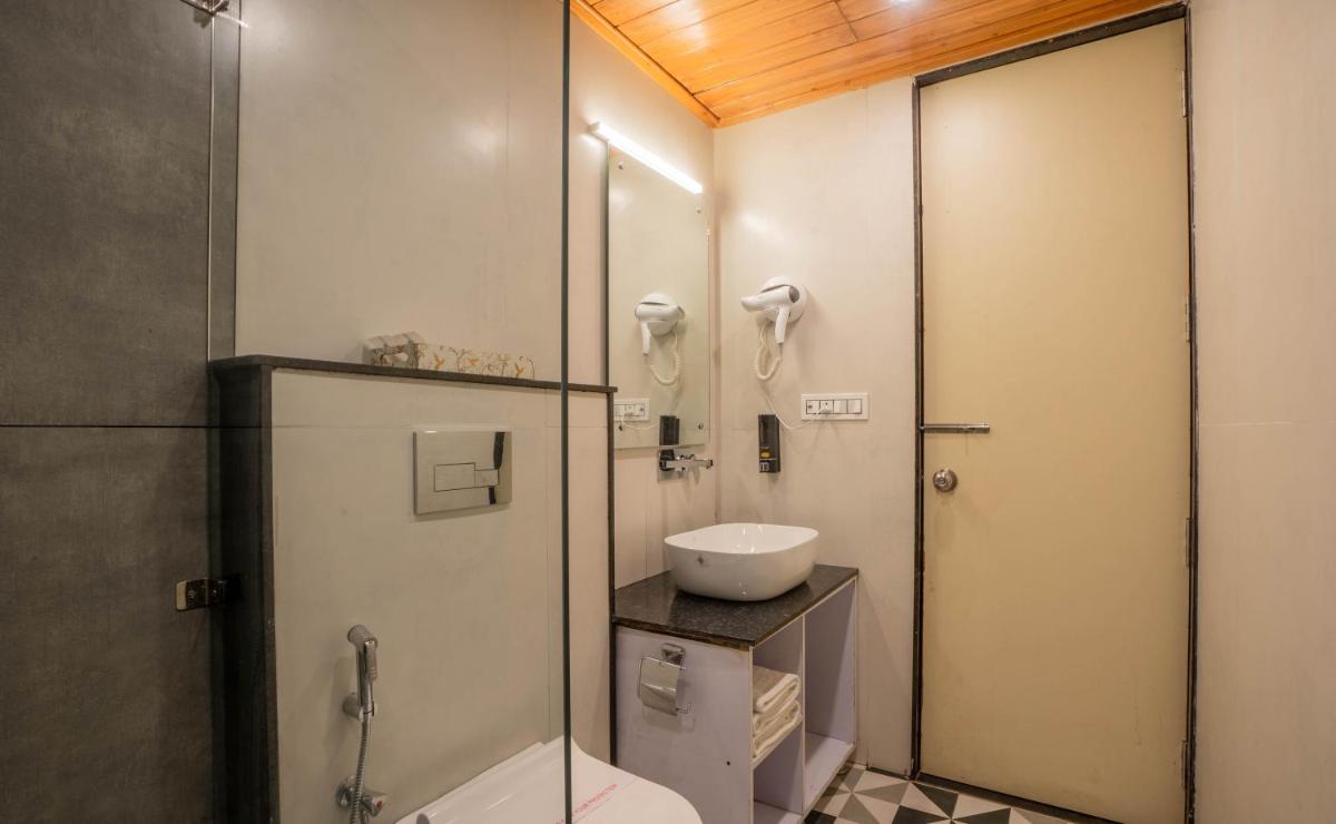a bathroom with a shower and a toilet and a sink at Perfectstayz Premium Westend at Mall Road in Mussoorie