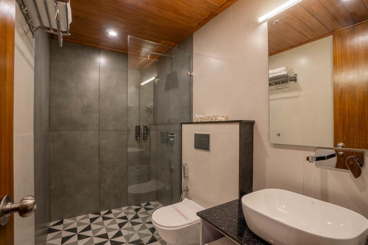 a bathroom with a shower and a toilet and a sink at Perfectstayz Premium Westend at Mall Road in Mussoorie