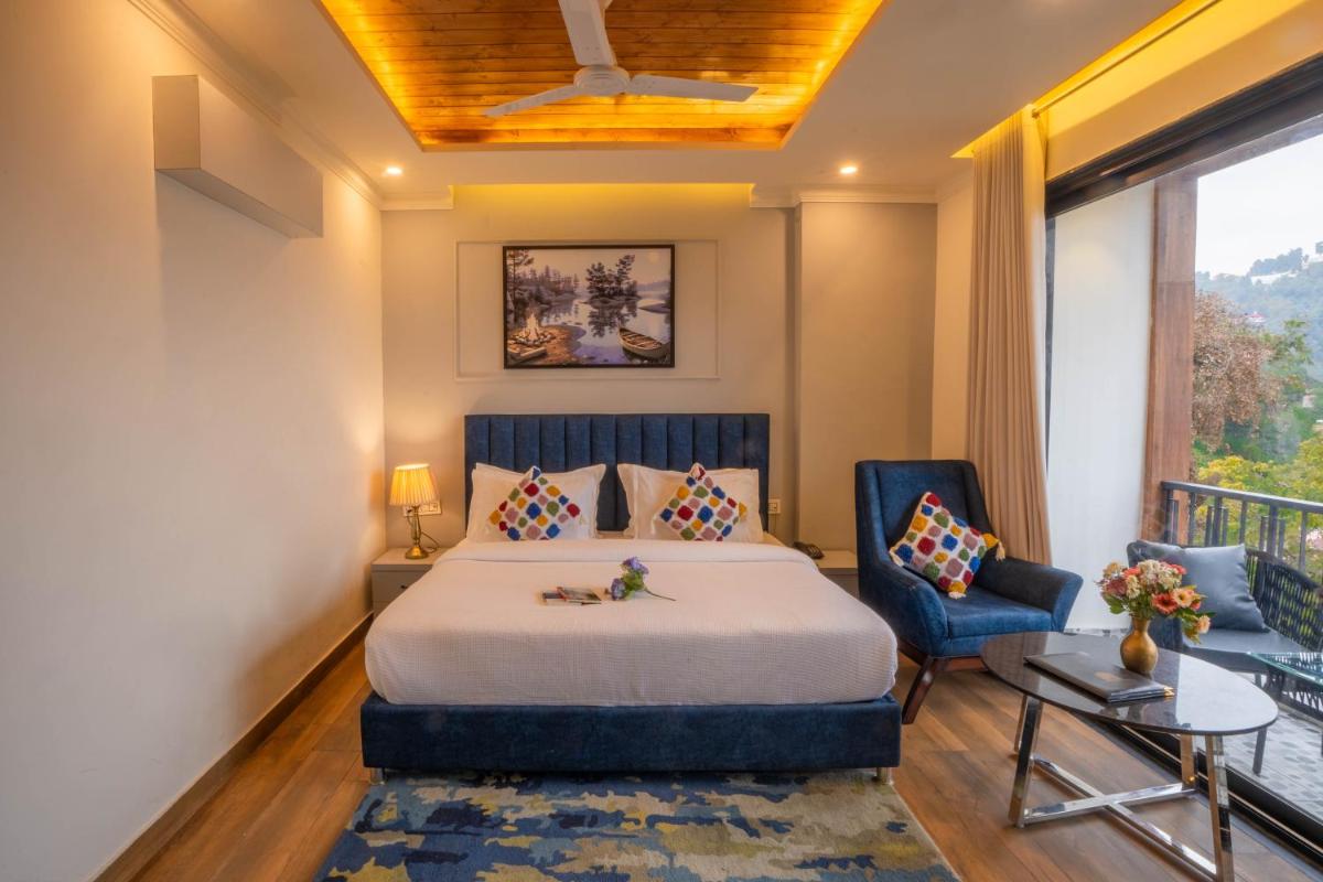 a hotel room with a bed and a balcony at Perfectstayz Premium Westend at Mall Road in Mussoorie