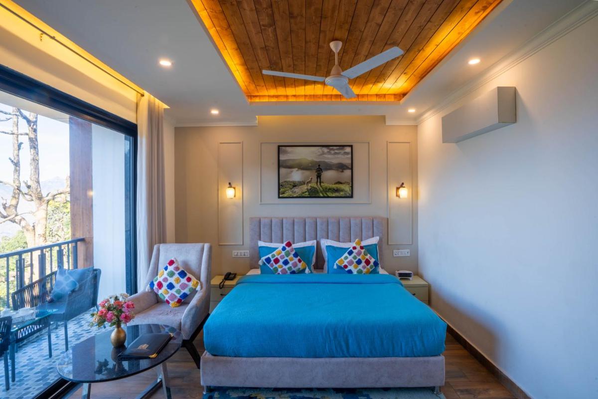 a bedroom with a bed and a ceiling fan at Perfectstayz Premium Westend at Mall Road in Mussoorie