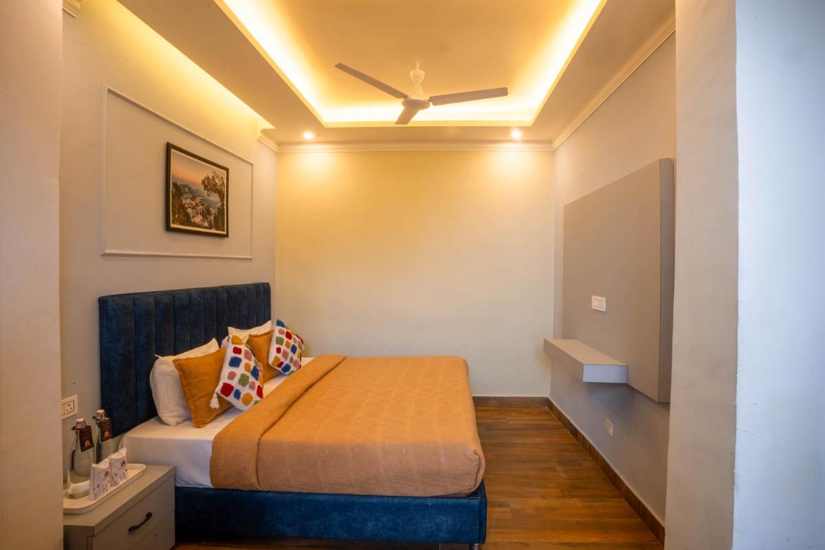 a bedroom with a bed and a ceiling at Perfectstayz Premium Westend at Mall Road in Mussoorie