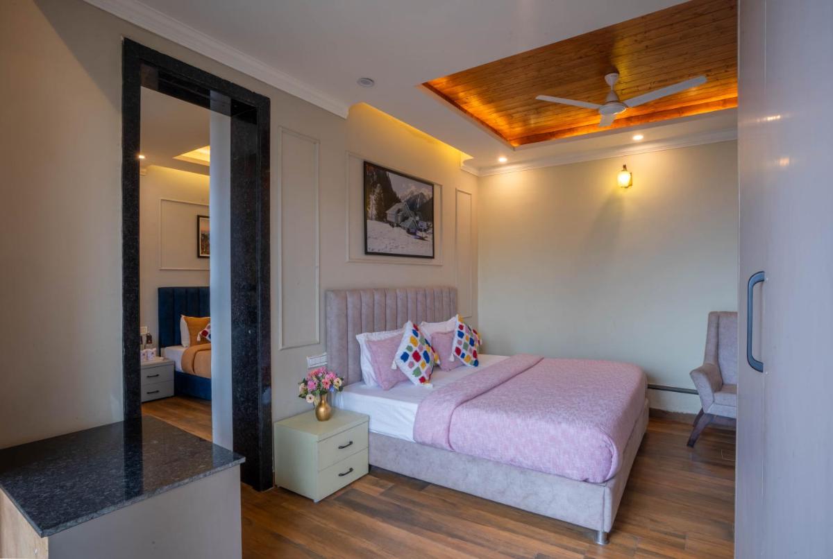 a bedroom with a bed and a mirror at Perfectstayz Premium Westend at Mall Road in Mussoorie