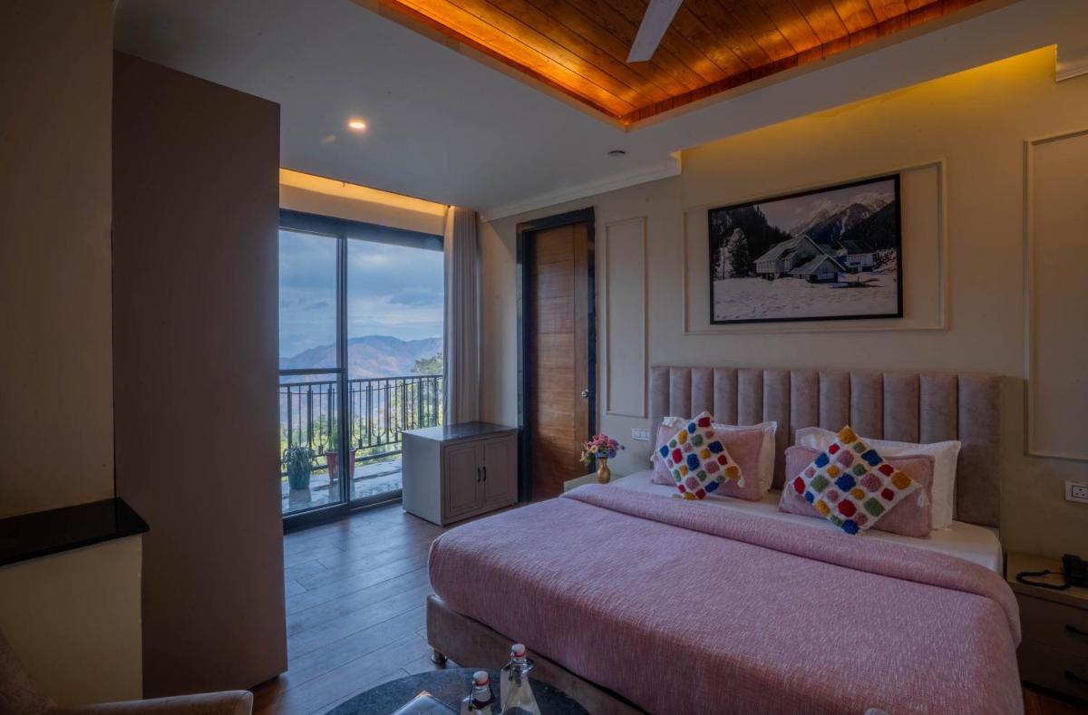 a bedroom with a large bed and a balcony at Perfectstayz Premium Westend at Mall Road in Mussoorie