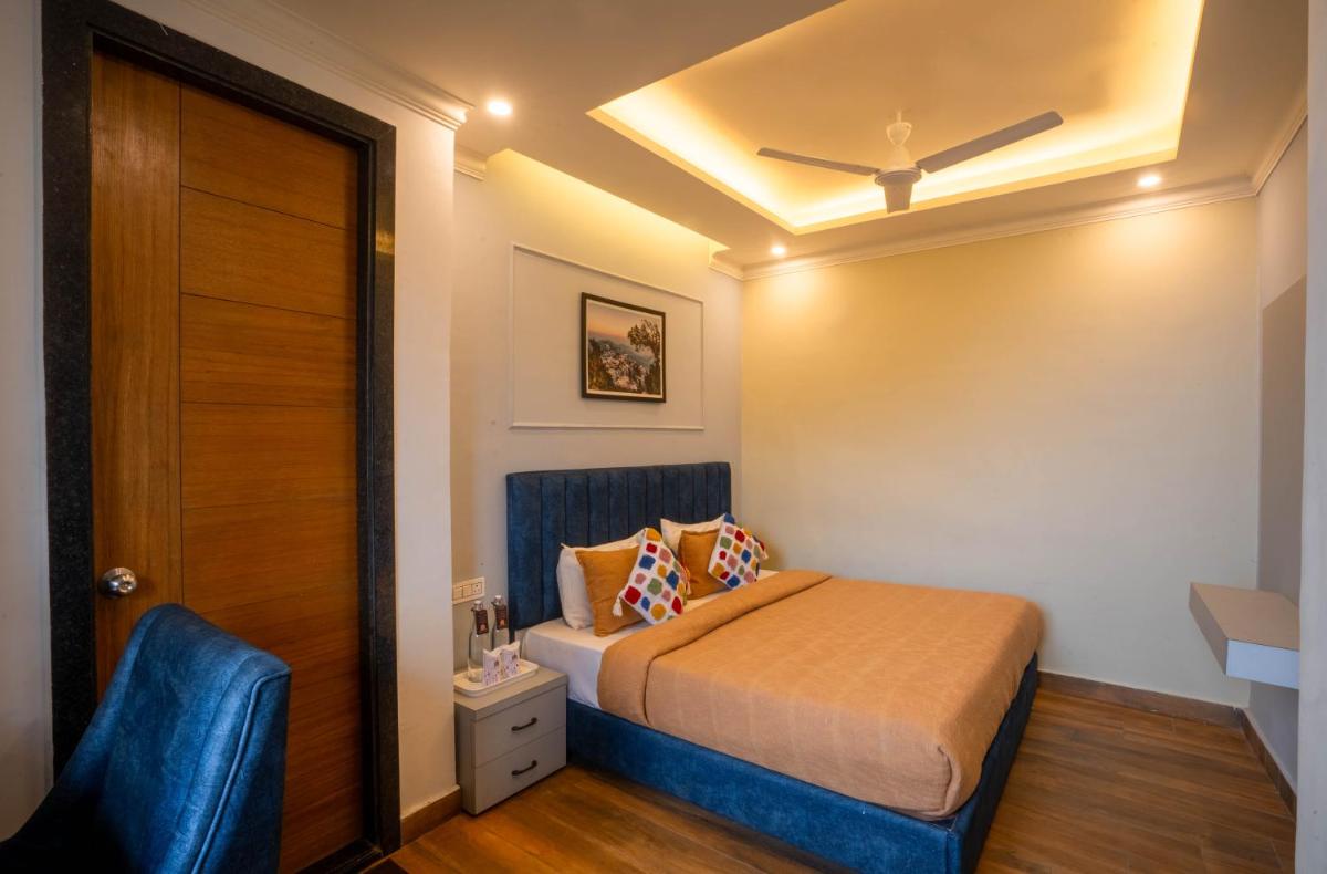 a small room with a bed and a door at Perfectstayz Premium Westend at Mall Road in Mussoorie