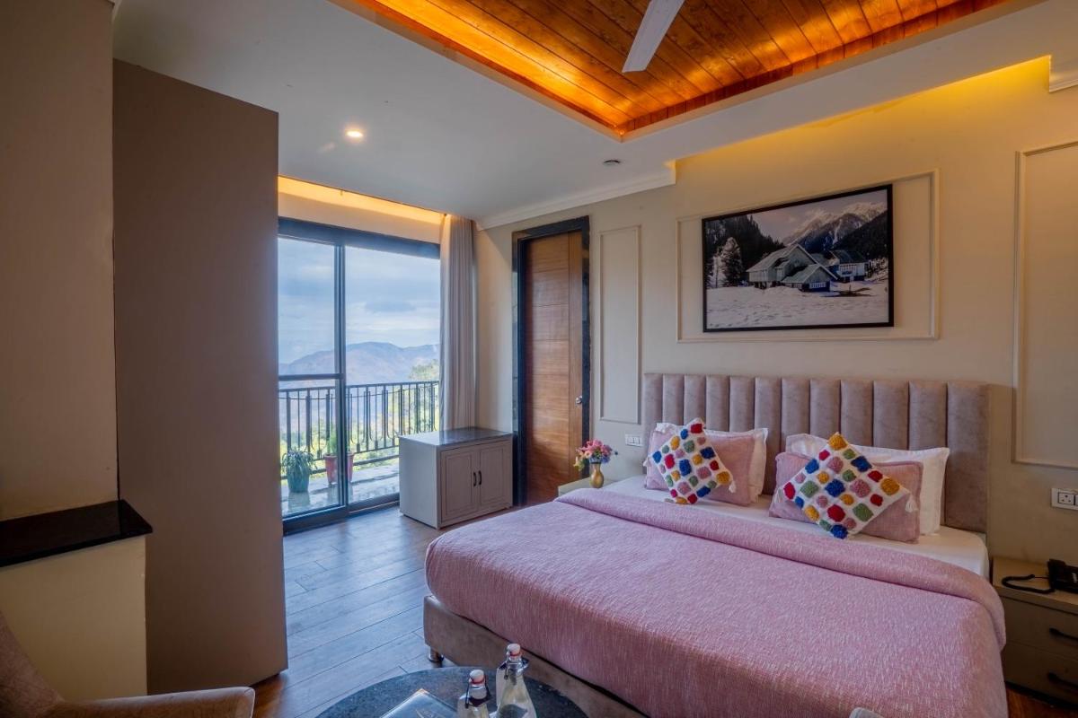 a bedroom with a large bed and a balcony at Perfectstayz Premium Westend at Mall Road in Mussoorie
