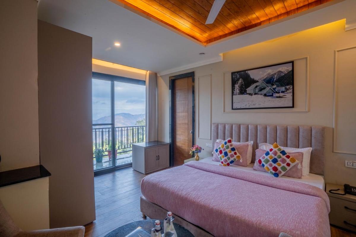 a bedroom with a large bed and a balcony at Perfectstayz Premium Westend at Mall Road in Mussoorie