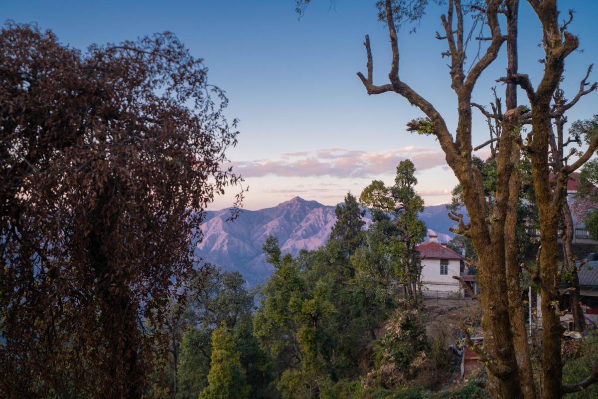 a view of a mountain with trees and a house at Perfectstayz Premium Westend at Mall Road in Mussoorie
