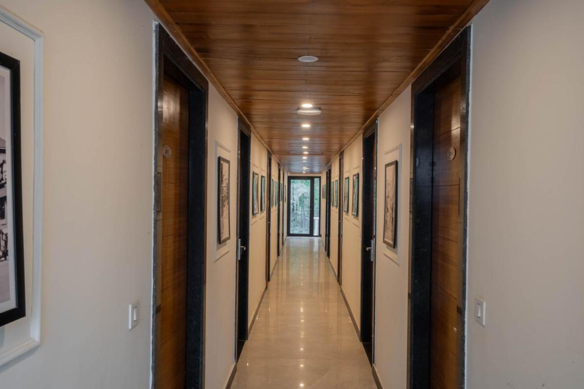 a hallway with wood ceilings and a long hallway with paintings at Perfectstayz Premium Westend at Mall Road in Mussoorie