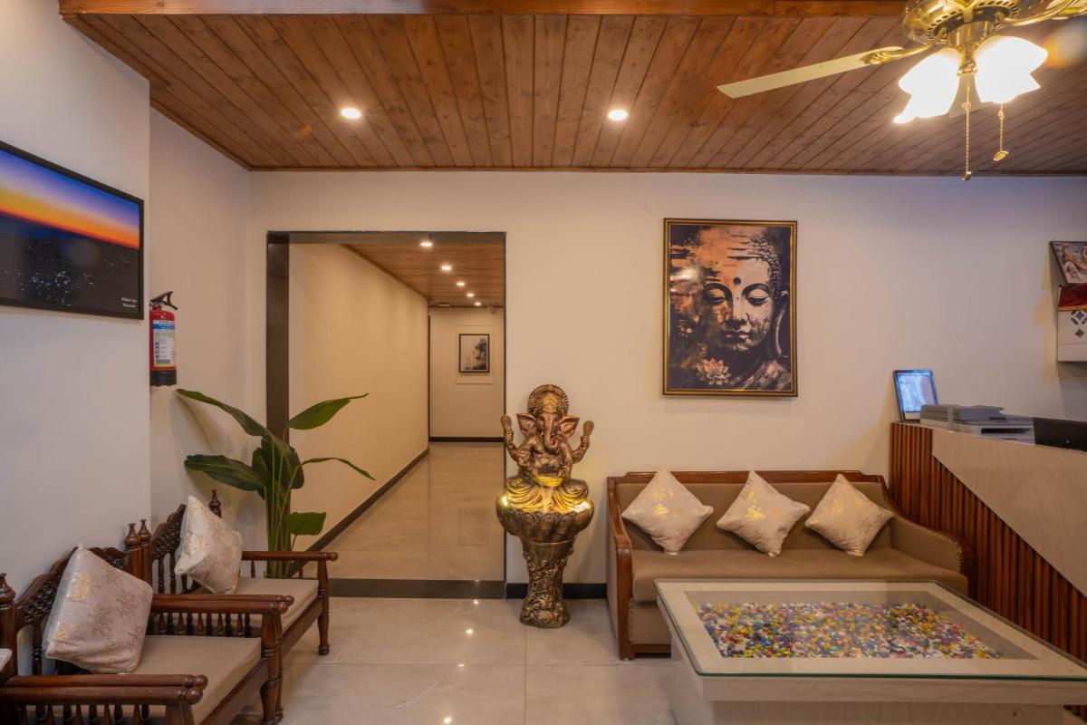 a living room with a couch and a statue at Perfectstayz Premium Westend at Mall Road in Mussoorie