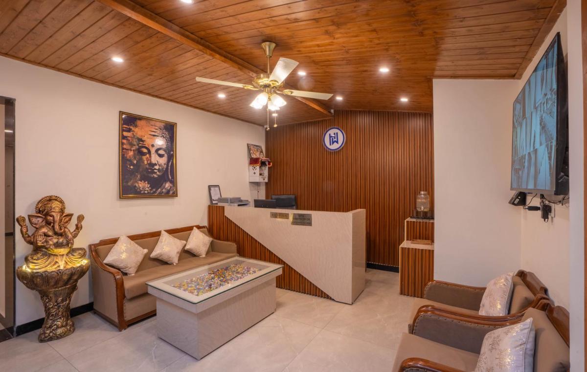 a living room with a couch and a ceiling fan at Perfectstayz Premium Westend at Mall Road in Mussoorie