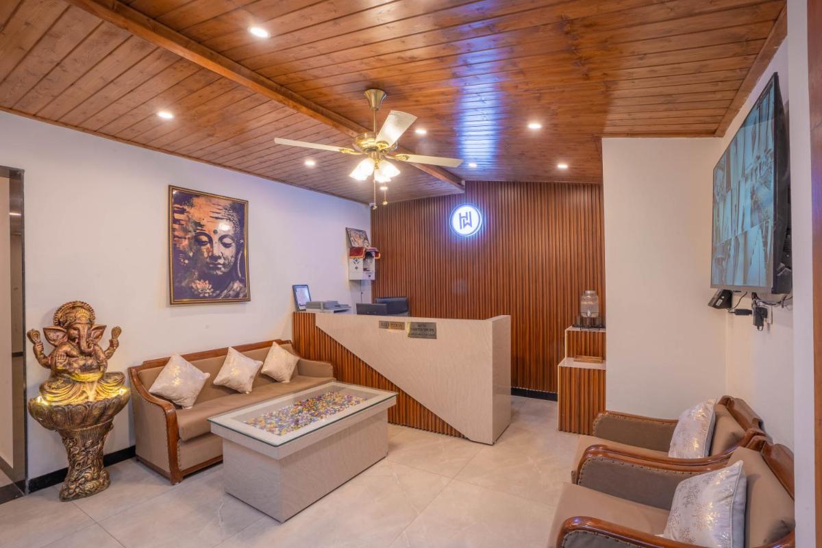 a living room with a couch and a ceiling fan at Perfectstayz Premium Westend at Mall Road in Mussoorie