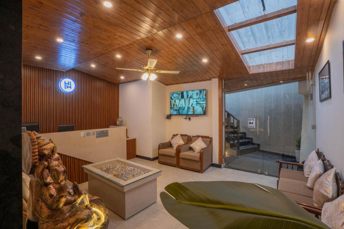a living room with a ceiling fan and a couch at Perfectstayz Premium Westend at Mall Road in Mussoorie