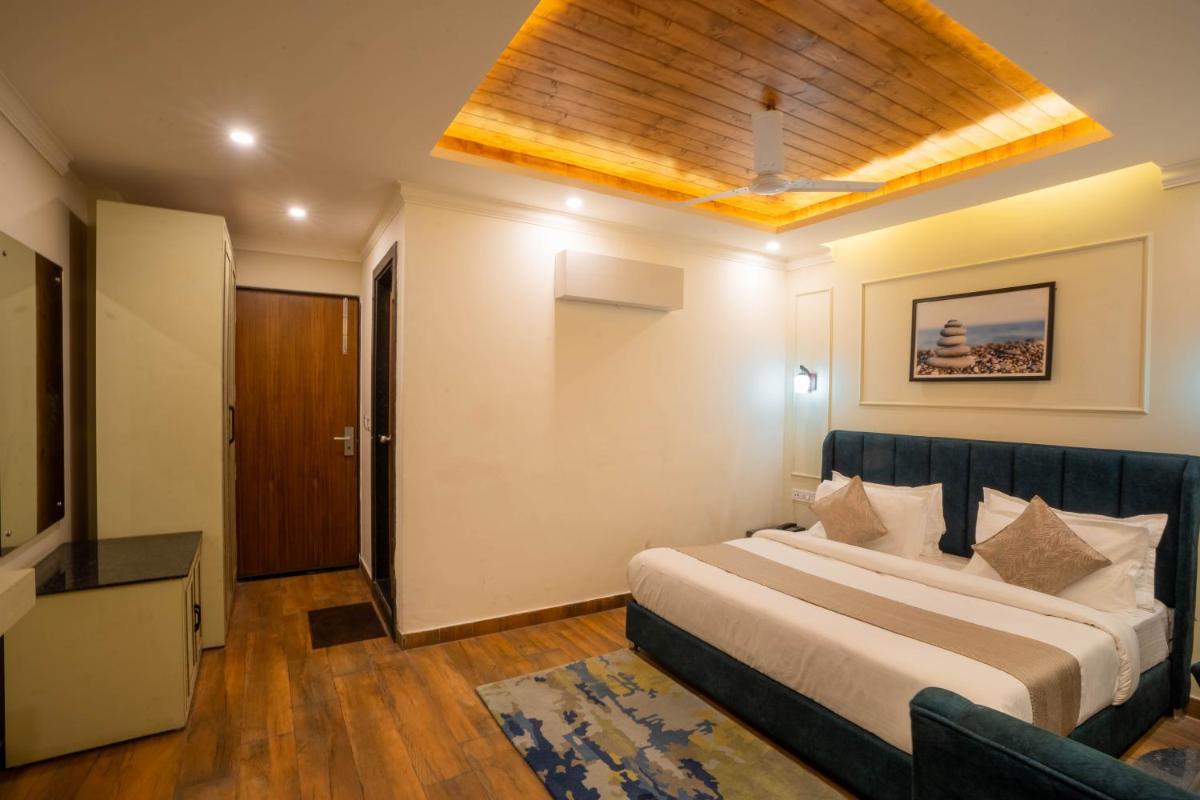 a hotel room with a bed and a television at Perfectstayz Premium Westend at Mall Road in Mussoorie