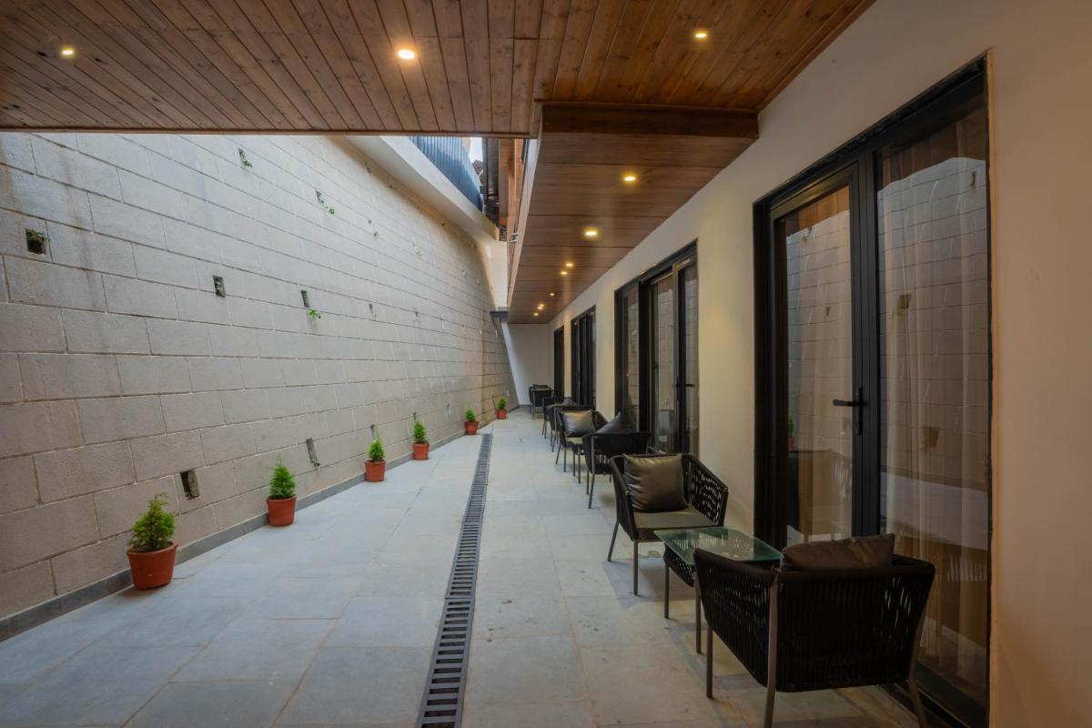 a hallway with chairs and tables in a building at Perfectstayz Premium Westend at Mall Road in Mussoorie