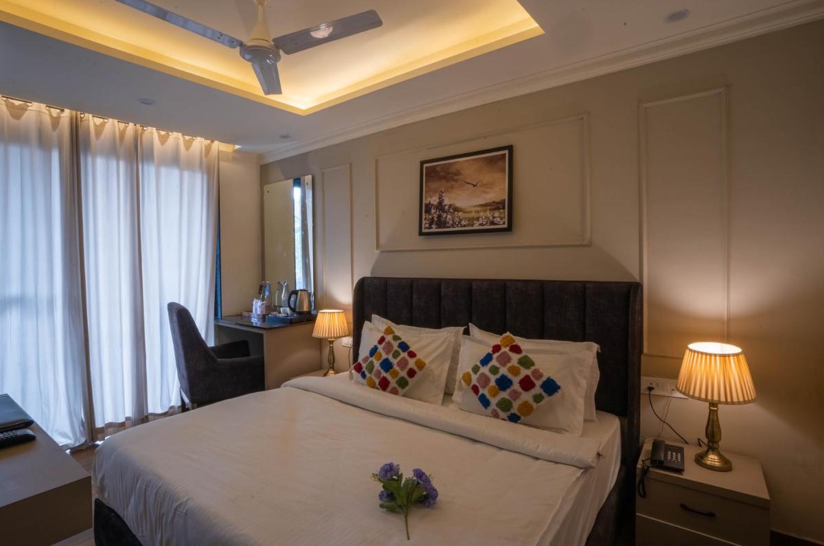 a hotel room with a bed with flowers on it at Perfectstayz Premium Westend at Mall Road in Mussoorie