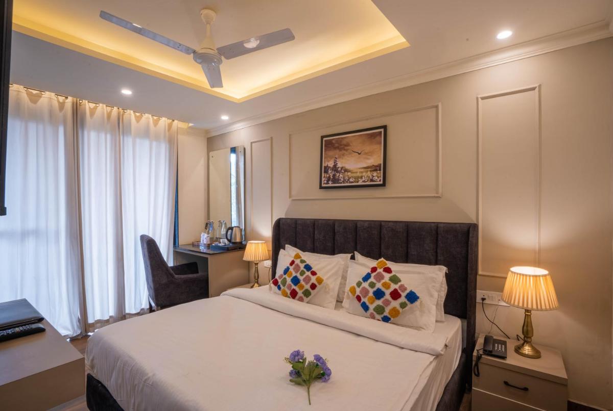 a hotel room with a bed and a desk at Perfectstayz Premium Westend at Mall Road in Mussoorie