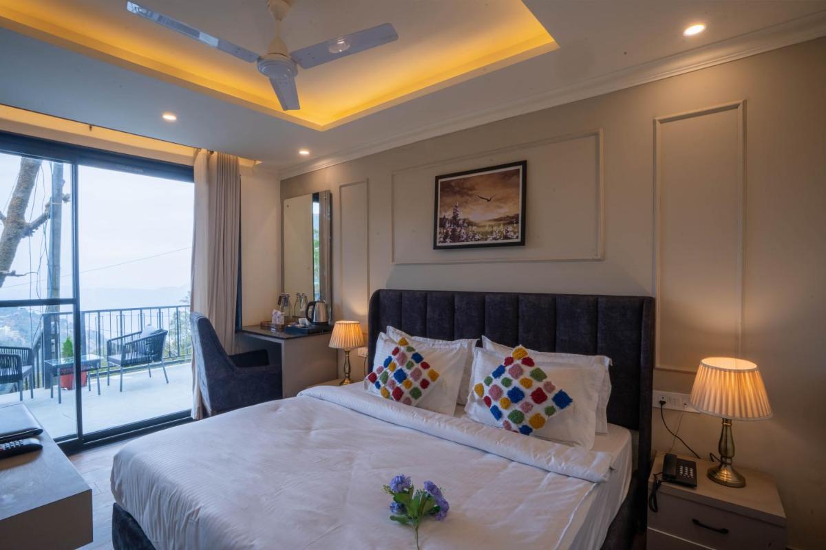 a hotel room with a bed and a balcony at Perfectstayz Premium Westend at Mall Road in Mussoorie