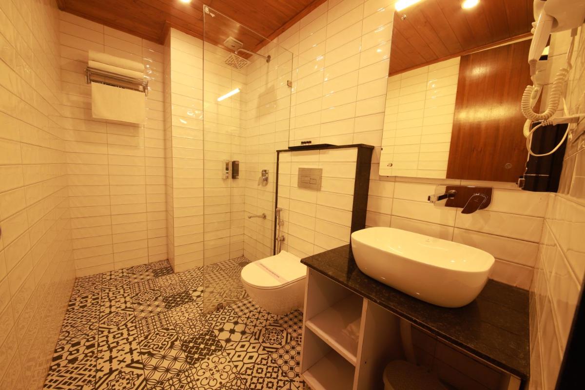 a bathroom with a sink and a toilet at Perfectstayz Premium Westend at Mall Road in Mussoorie